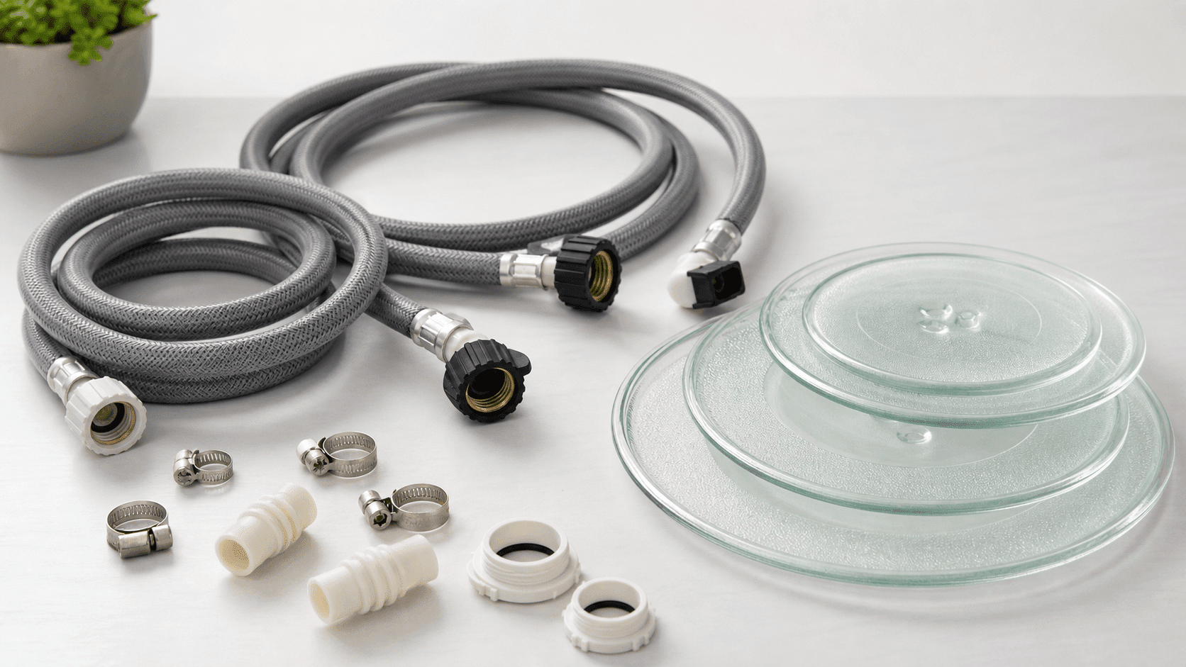 Selection of high-quality spare parts like durable washing machine hoses and long-lasting microwave plates arranged on a table